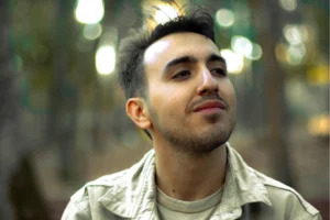 Man in an outdoor setting looking reflective