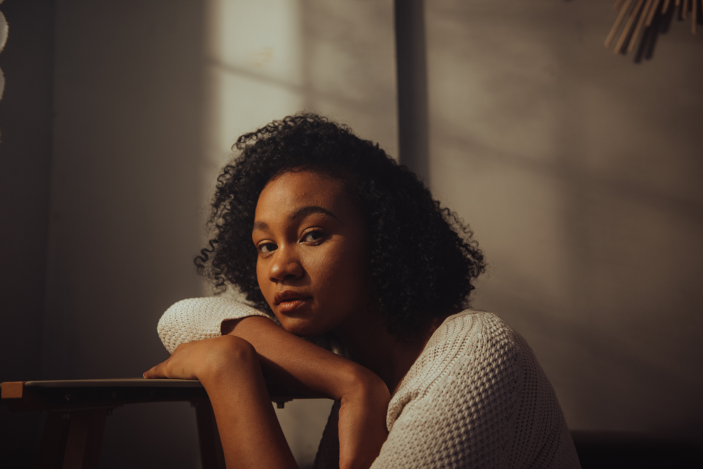 Person looking thoughtful and unsure, representing the hesitation some people feel before asking for mental health support