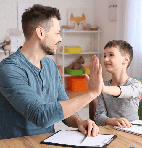 Clinician supporting a child during an autism assessment