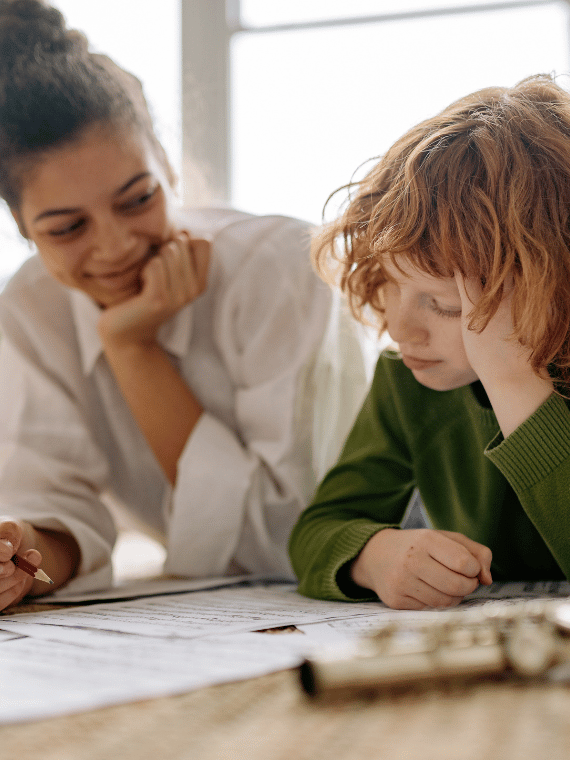Mental health professional supporting a child during a therapy session