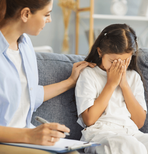 Child receiving support during a psychiatry assessment with a mental health professional