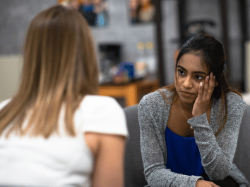 Mental health professional speaking with a woman during a support session